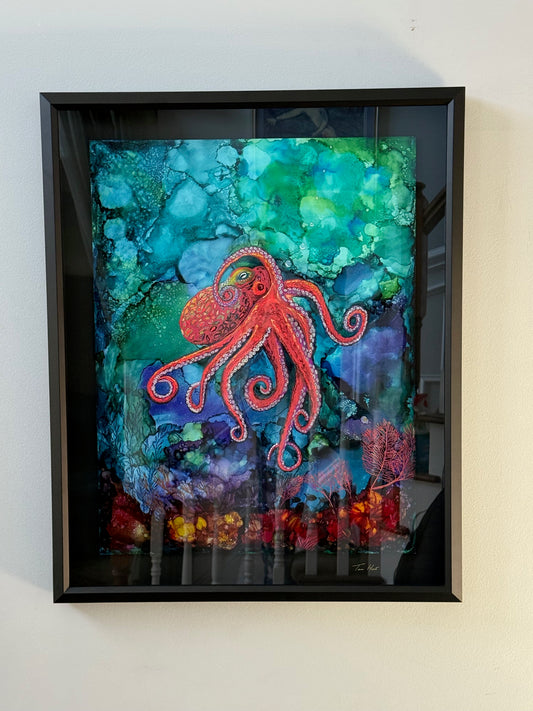 Framed abstract octopus art in vibrant colors on alcohol ink, featuring a red octopus on a blue-green background.